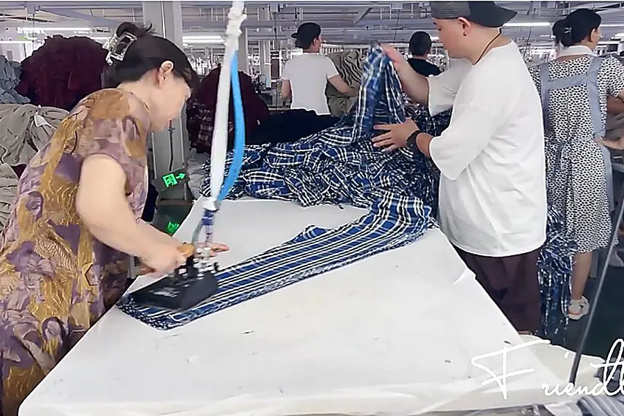 inside pajama factory pressing station